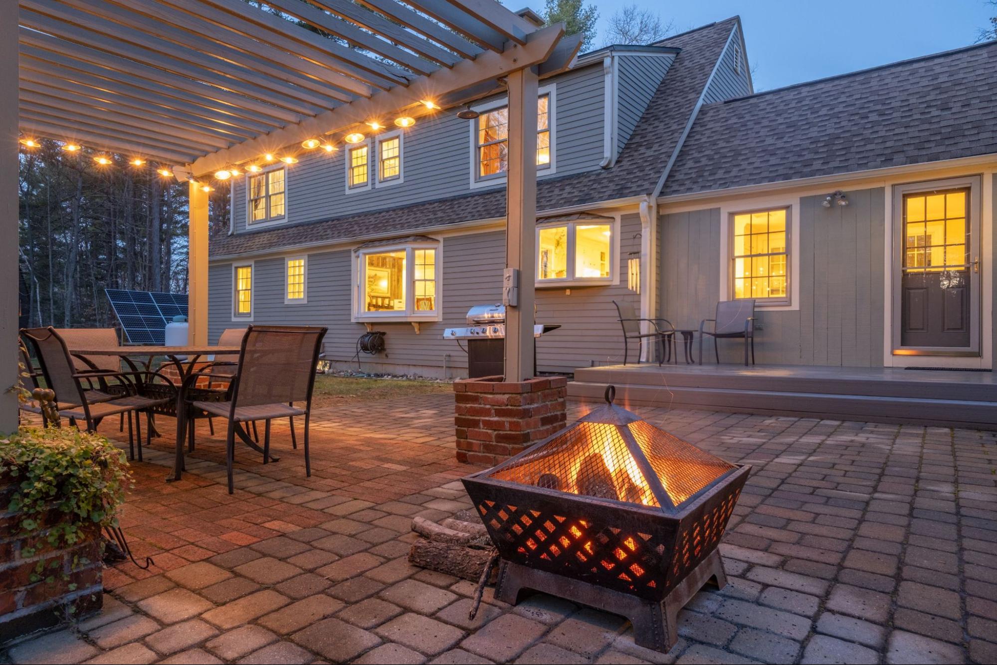 Outdoor patio with patio furniture and a firepit. 