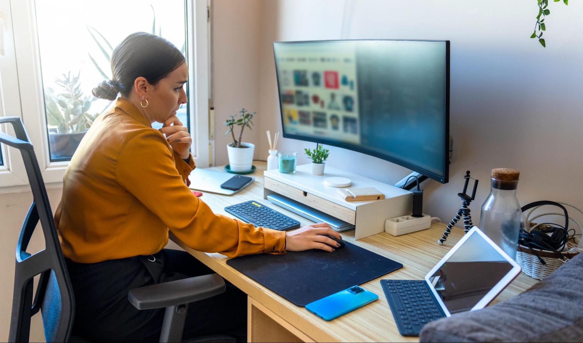 WOman using her computer in a home office.